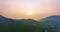 Beautiful sunrise or sunset over wild forest mountains in summer morning time