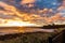 A beautiful sunrise at Tynemouth`s King Edward`s Bay with the sunlight catching the underside of the clouds