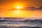 Beautiful sunrise wave and dramatic cloudscape during scenic sunrise over the sea