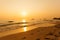 Beautiful sunset above the sea. Footprints in the sand.