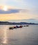 Beautiful sunset on Aegean coast with islands and mountains, boats and catamarans