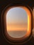 Beautiful sunset in the aircraft`s porthole window