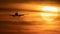 Beautiful sunset with airplane landing and fuel trail