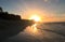 Beautiful sunset on the Atlantic coast of Cuba. View of the ocean, waves and rays of the sun on the horizon