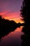 beautiful sunset in autumn season. trees silhouette near a river