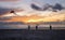 Beautiful sunset on the beach and people taking a parachute in t