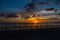 Beautiful sunset on the beach.The silhouette of the fence. The setting sun over the horizon. Pandan, Panay, Philippines.