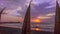 Beautiful sunset on the beach, view of the pier and traditional totora boats.