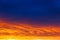 Beautiful sunset. Colorful dramatic sky at sunset. Layered rain clouds. Bright blue orange background