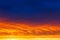 Beautiful sunset. Colorful dramatic sky at sunset. Layered rain clouds. Bright blue orange background