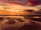 Beautiful sunset colors over the coastline of Allerdale district in Cumbria, UK. Sun setting over the shore of Allonby bay on