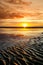 Beautiful sunset colors over the coastline of Allerdale district in Cumbria, UK. Sun setting over the shore of Allonby bay on