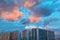 Beautiful sunset in the dormitory area. Sunset in the city. View of buildings with colorful clouds above.
