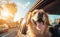 Beautiful sunset golden hour light photo of smiling Golden Retriever cute dog in fancy sunglasses during evening car city tour