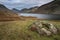 Beautiful sunset landscape image of Wast Water and mountains in