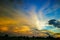 Beautiful sunset landscape over a plain wild grass field and a forest on background