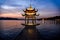 The beautiful Sunset landscape scenery of Xihu West Lake and pavilion with boat and mountain in Hangzhou China