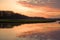 Beautiful sunset in the meadow with a great water reflection.