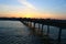 Beautiful sunset next to a long pier