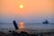 Beautiful sunset with old rusty fishing boat parked on a sandy