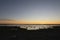 Beautiful sunset over an arctic landscape with rocks in the foreground