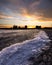 Beautiful sunset over Humber Bay, with ice washing up on the lake shore and lining the coast
