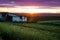 Beautiful sunset over humble farm and shack during peak harvest