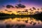 Beautiful sunset over the lake near the golf course in a tropical resort, Punta Cana