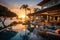 A beautiful sunset over a lavish beachfront villa, complete with crystal clear pools, lush greener