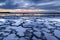 Beautiful sunset over the ocean with rocky beach and tidal pools in the foreground