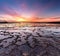 Beautiful sunset over the ocean with rocky beach and tidal pools in the foreground