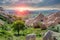 Beautiful sunset over the pyramidal tuff mountains  in Red Valley in Cappadocia. Turkey