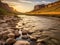 Beautiful sunset over river, with rocks and mountains in background. The scene is serene and picturesque, as setting