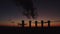 Beautiful sunset over a smoking thermal power plant. The sun moves over cooling towers and chimneys. Thick smoke rises