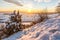 Beautiful sunset over snowy winter landscape in the Swabian Alps with trees in the foreground