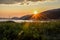 Beautiful sunset over Tadoussac bay and grassy field