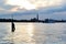 Beautiful sunset over the Venice lagoon, cloudscape, cityscape of the island of San Giorgio Maggiore and a ferry crossing the bay.