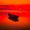 Beautiful sunset over water and silhouette of fishing boat