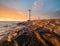 Beautiful sunset over a windmill-shaped lighthouse, Swinoujscie, Poland.