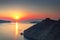 Beautiful sunset overlooking the Aegean Sea, island of Santorini, Greece, Europe. View of the rocks, caldera, volcano, islands,