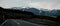 Beautiful sunset panorama of the Haast Pass road with snow capped mountains in the background on a winter day, New Zealand