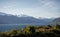 Beautiful sunset panorama at Wanaka lake with snow capped mountains in the background on a winter day, New Zealand