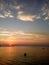 Beautiful sunset at Peraia, suburb of Thessaloniki, Greece. Silhouettes swimming in the sea.