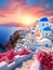 Beautiful sunset of picturesque Santorini island, Greece. Blue-domed churches and white-washed houses