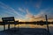 Beautiful sunset reflecting on the water at the public boat landing and dock with bench on Little Moon Lake, Barron County WI