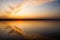 Beautiful sunset with reflection on the lake, clouds in shape of wings. Calm water, vertical shot