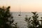 Beautiful sunset in Salento on the Adriatic Sea, a yacht bobbing in the sun path, blurred scenic shadows on the sides, Apulia,