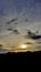 Beautiful sunset scenery on-mountain In the evening, with a silhouette of trees in forest and orange sky