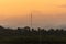 Beautiful sunset scenic of moutain and coconut woods in suburb of Thailand with telecommunication pole in the middle of the photo