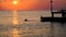 Beautiful sunset on sea. silhouette of guy jumping off pier into the Mediterranean sea